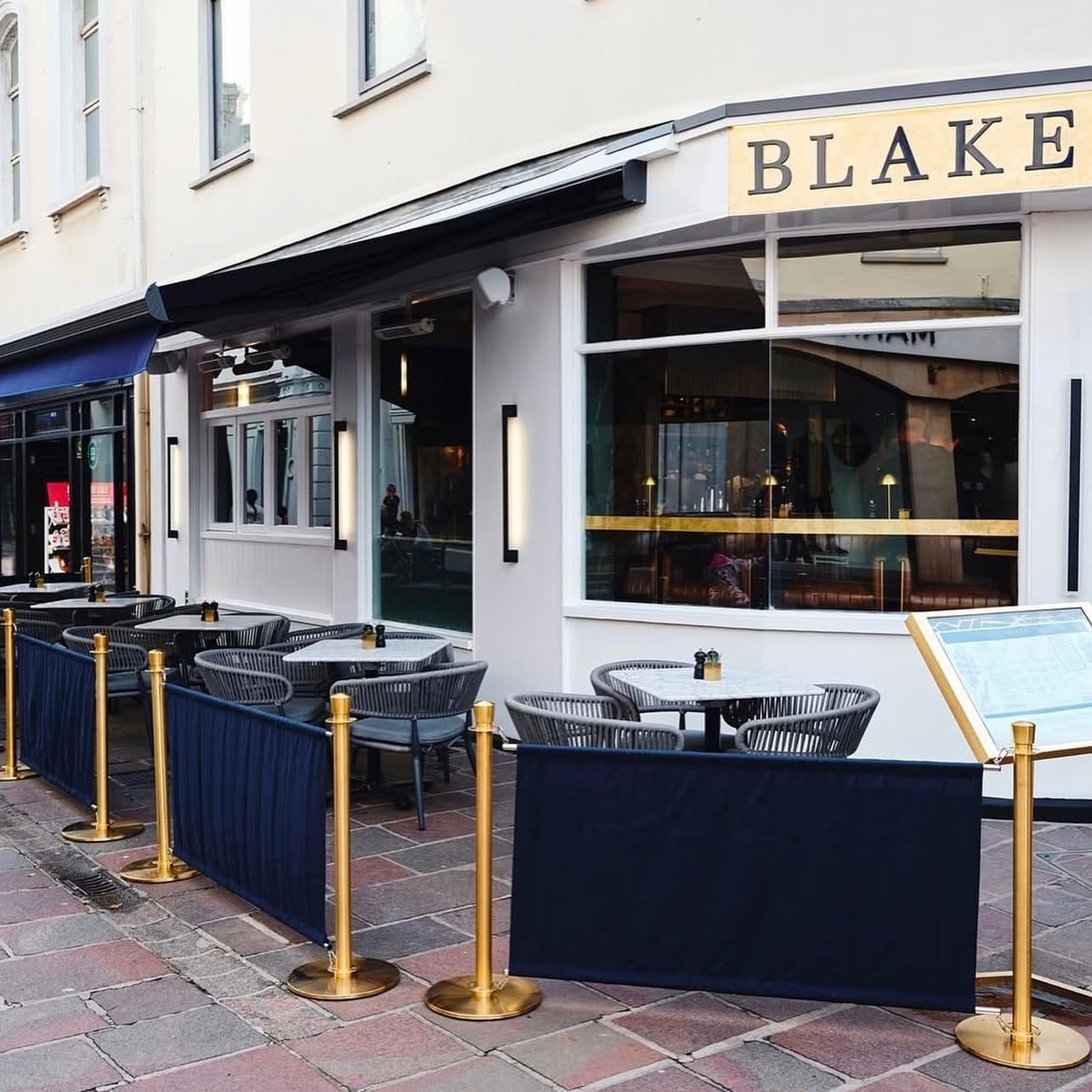 The Blakes King Street shopfront in St Helier with alfresco tables under a navy awning
