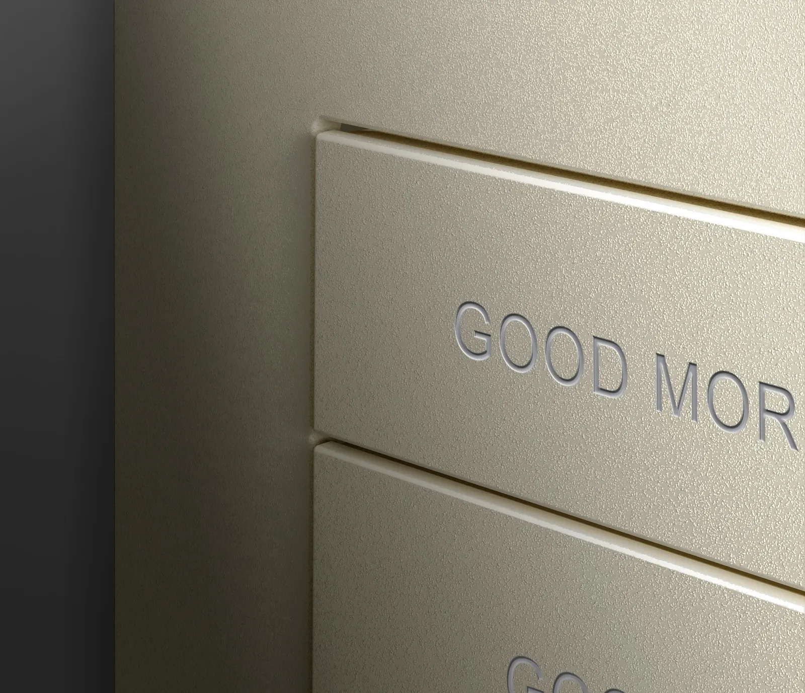 Close-up of a champagne-finish keypad button engraved Good Morning