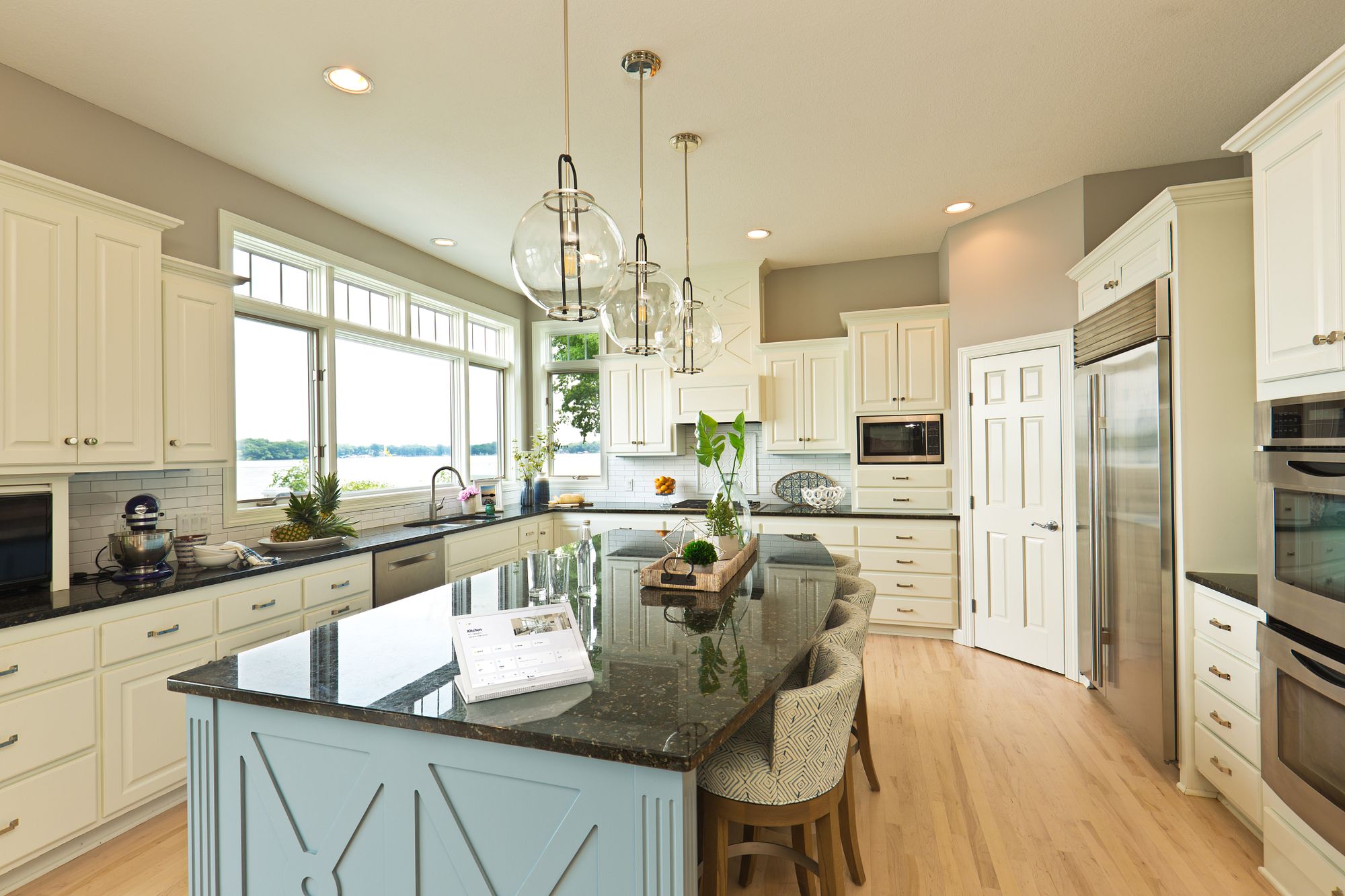 A kitchen island with a control screen for checking the house
