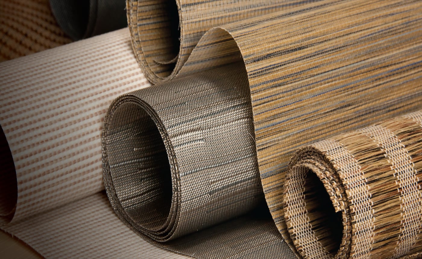 Rolls of designer roller-blind fabric in linen and grasscloth weaves