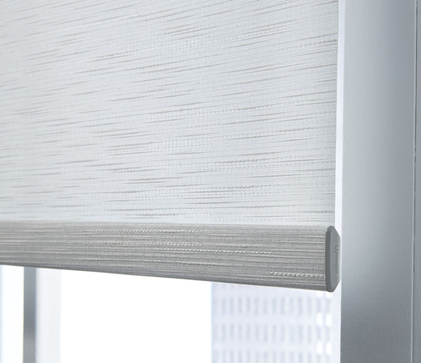 An automated roller blind in a textured fabric, partly lowered